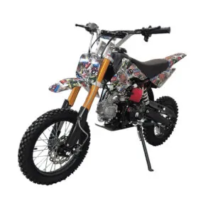 Off-road dirt bike with colorful graffiti decals, gold front forks, and a side kickstand.